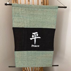 Decor, peace sign in Japanese. Green color with whit writing on black background